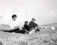 Mabel Hussey braiding on the beach. 