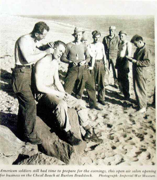US Army having a haircut on ther beach in WWII