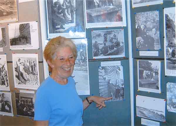 Liz (as she is now known) Mackay looking at her wartime picture when she was an evacuee in the village. 