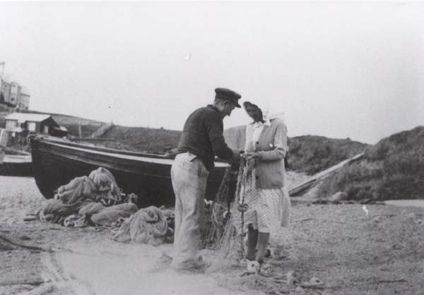 Swaffield & Mabel Hussey mending net at Hive Beach - 1930's