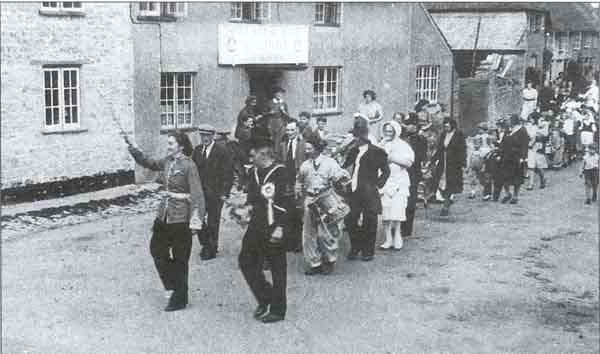 The celebrations for either VE or VJ Day are seen passing the Three Horseshoes Inn
