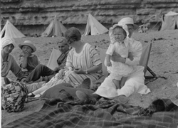 Family on beach - note tents in background for changing