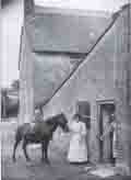Mr Henry Pout and his daughter outside his Burton Bradstock bakery before 1903