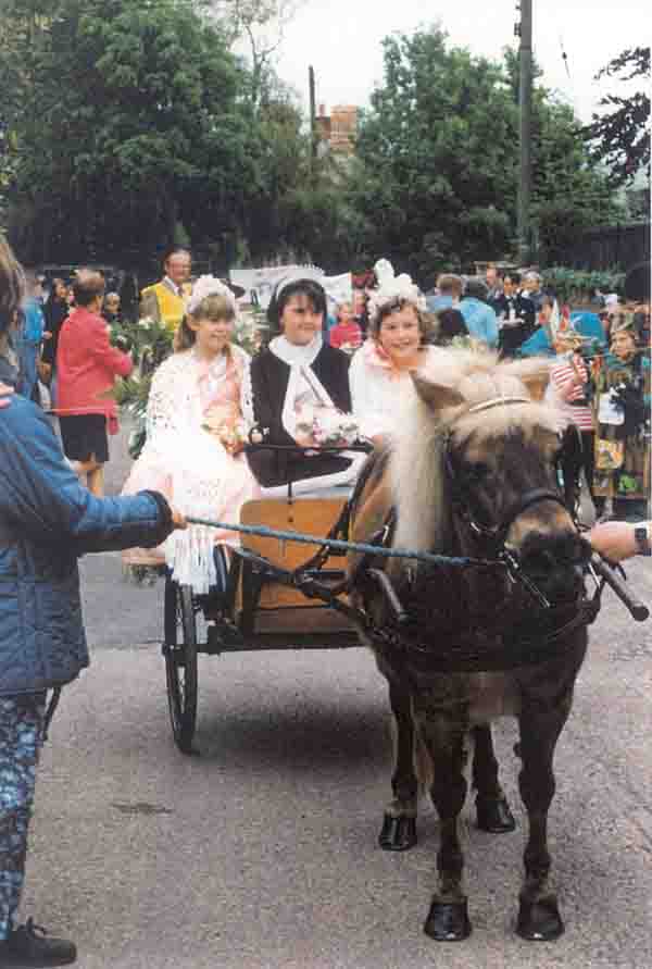 The Carnival Queen & her attendants in the pony & trap. Frank Bailey (in yellow) keeps an eye