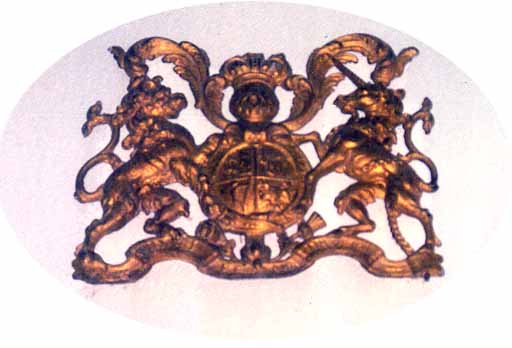 Over the south door, in gilded wood, the Royal Arms are of the Hanoverian period. 