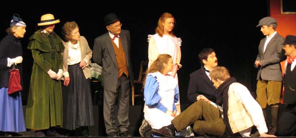 Chorus look on as the Children and Mr Perks try to help Mr Szczepansky (Richard Chubb)